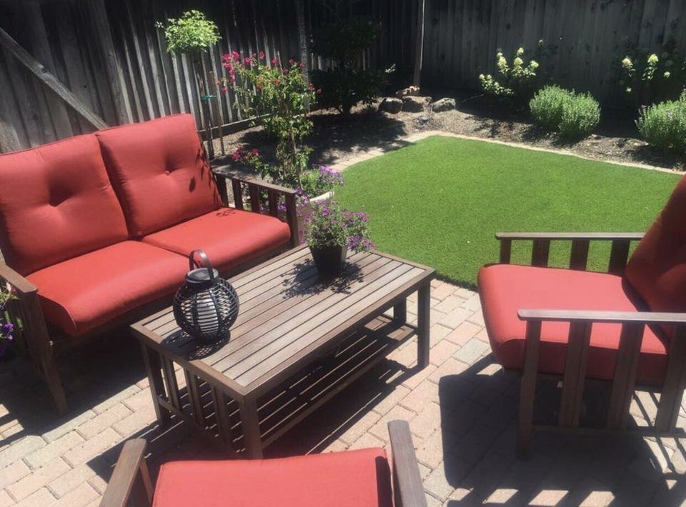 Synthetic turf lawn beside a patio with outdoor seating