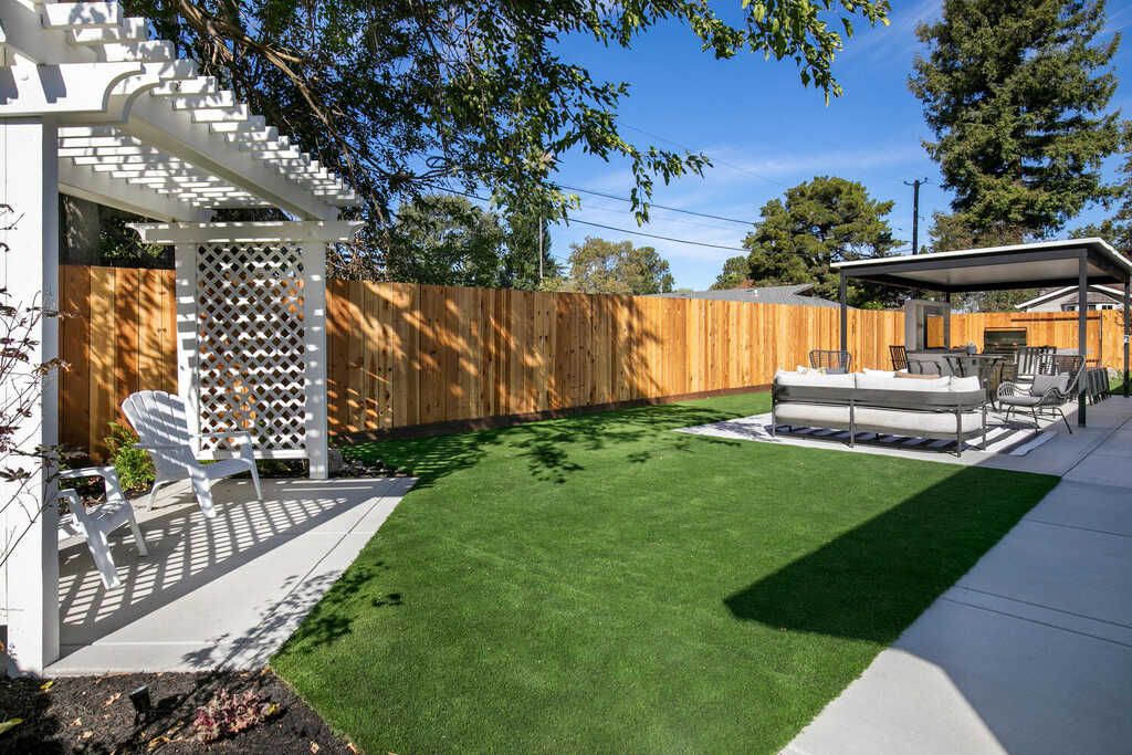 Cedar pergola patio cover over synthetic turf and concrete patio in a Pleasant Hill backyard