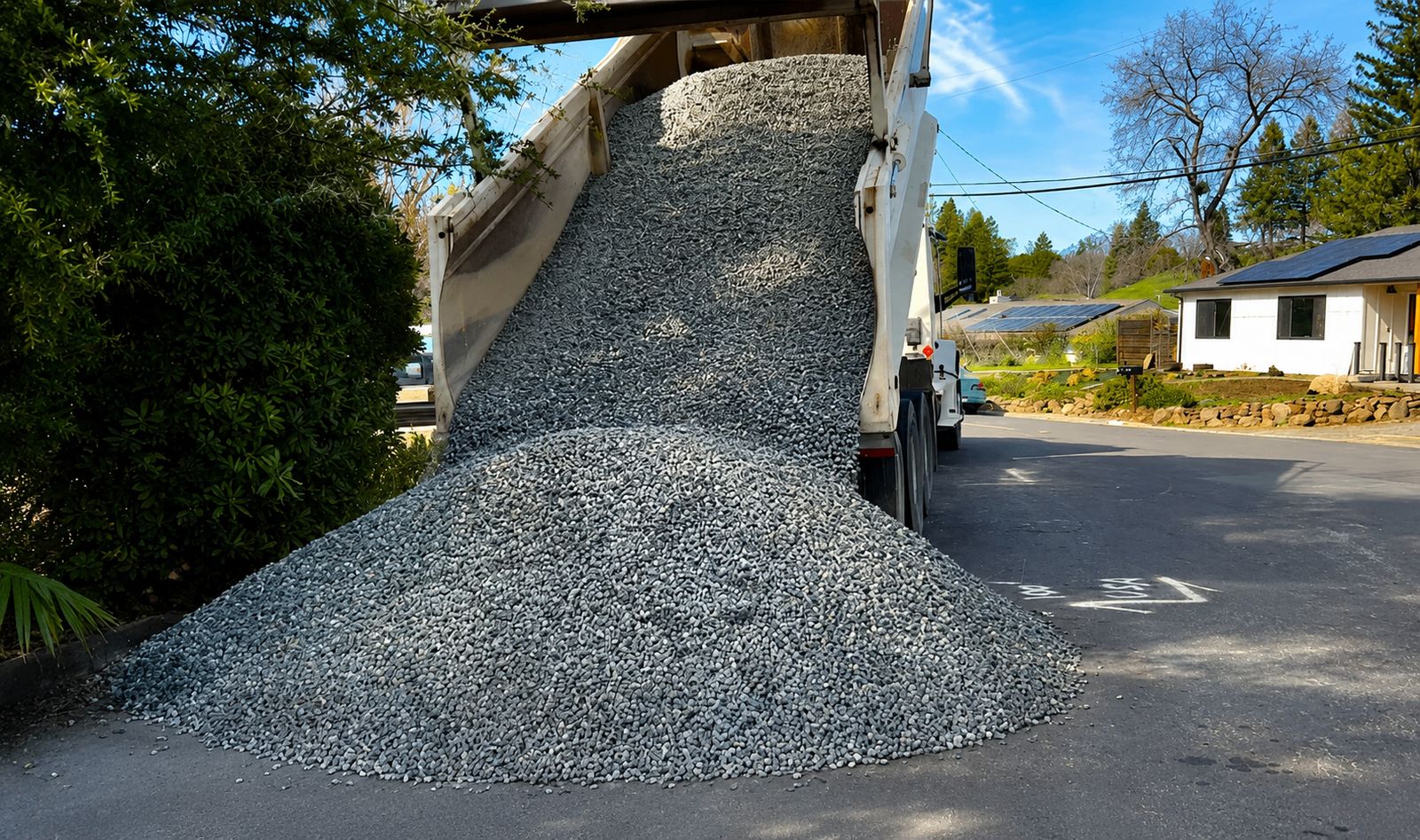 Old concrete patio being broken up and removed with a skid-steer in a Walnut Creek backyard