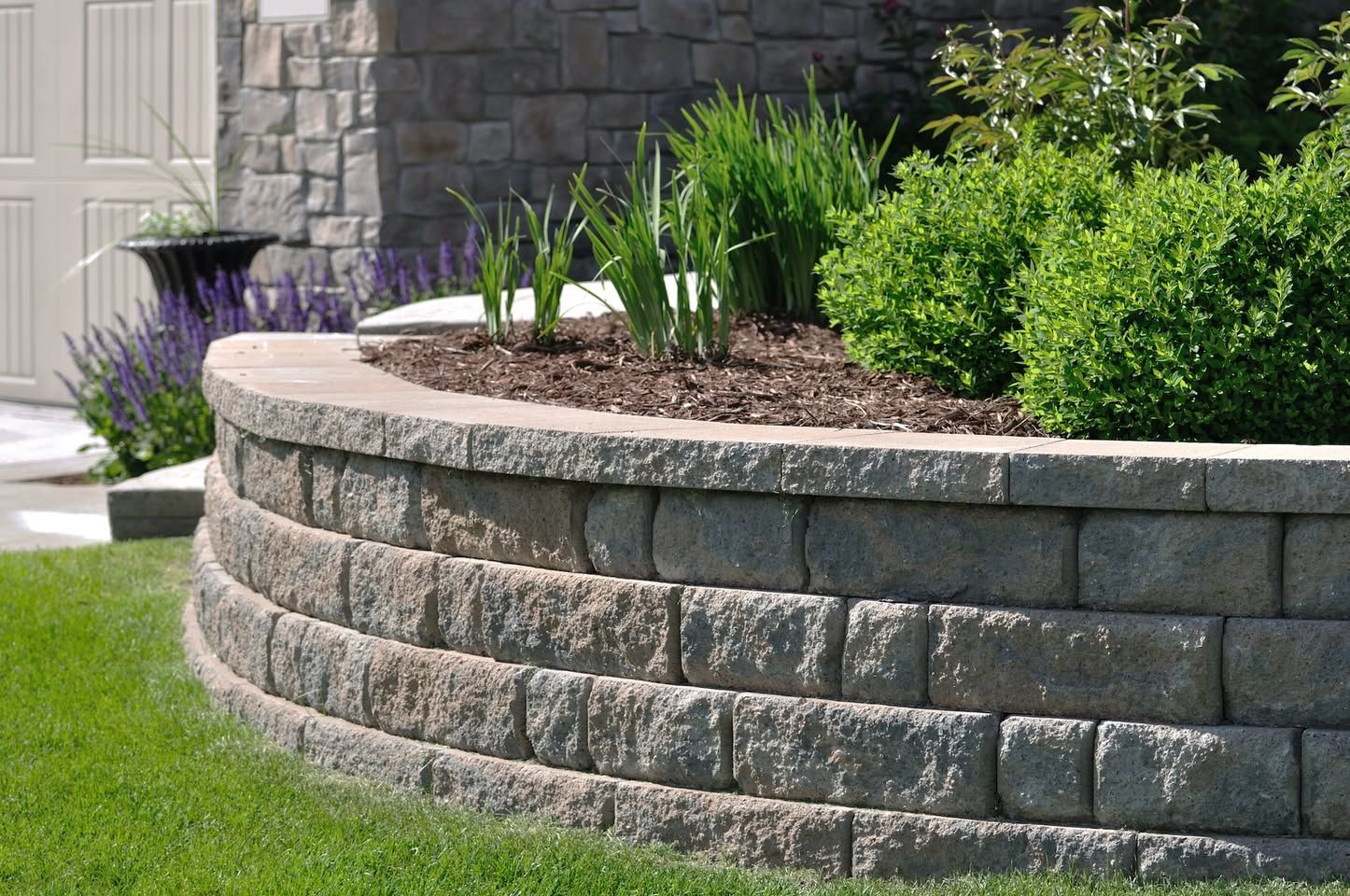 Curved segmental block retaining and planter wall along a front yard in Alamo